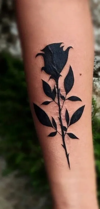 Minimalist black rose tattoo on forearm, artistic mobile wallpaper.