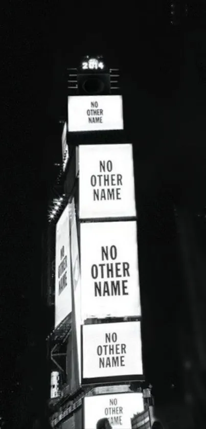 Black and white city skyline with lit signs at night.