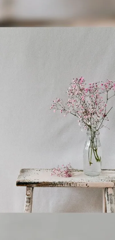 Minimalist wallpaper with pink blossoms on a bench.