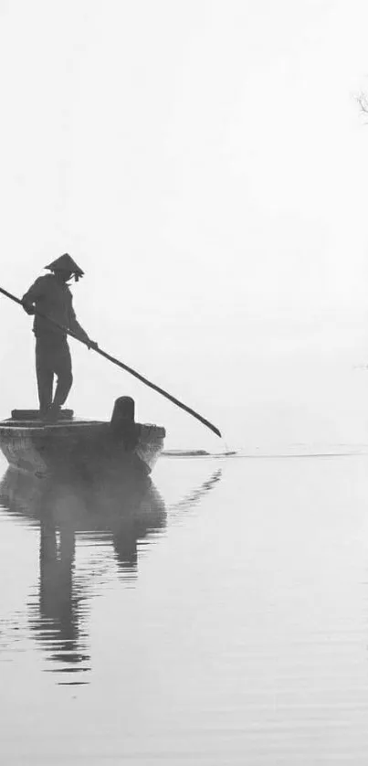 Minimalist black and white scene with a lone boatman and tree reflection.