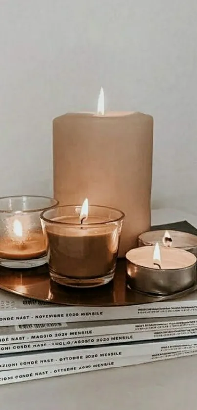 Minimalist candle decor on stacked books.