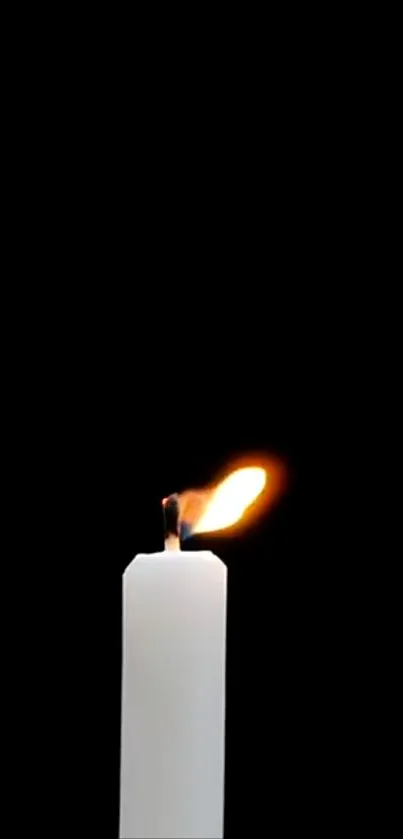 Minimalist candle flame on black wallpaper for mobile phone.