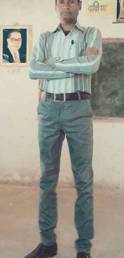 Man standing in a minimalist pastel classroom with portraits on wall.