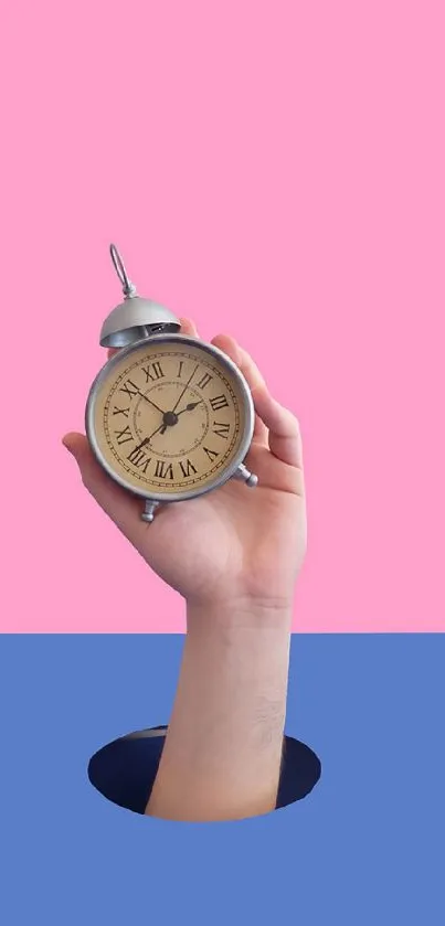 Hand holding a vintage clock against a pink and blue background.