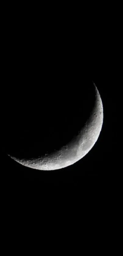 Minimalist crescent moon on black background wallpaper.