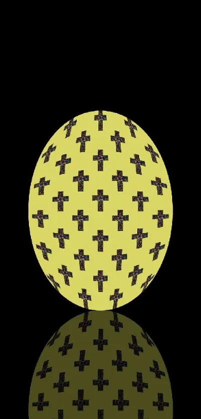 Yellow egg with black crosses on a black background wallpaper.