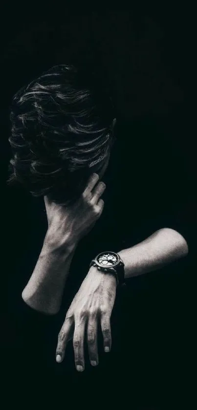 Dark moody portrait with a watch on black background.