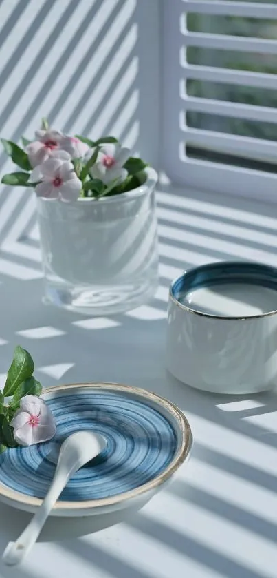 Minimalist coffee scene with flowers and shadows.