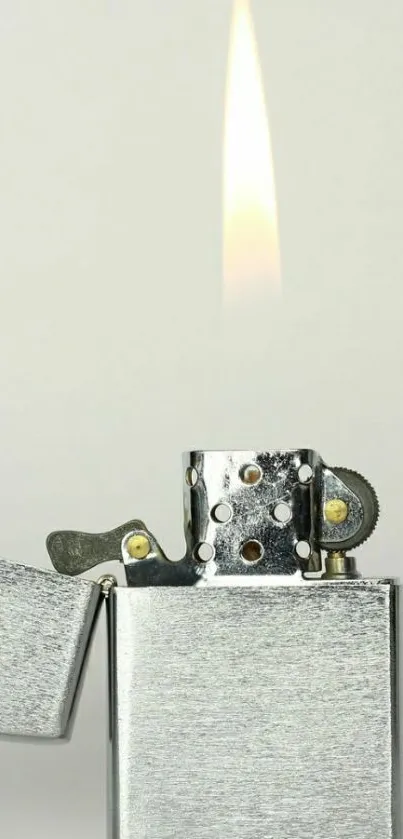 Minimalist silver lighter with flame, perfect for phone wallpaper.