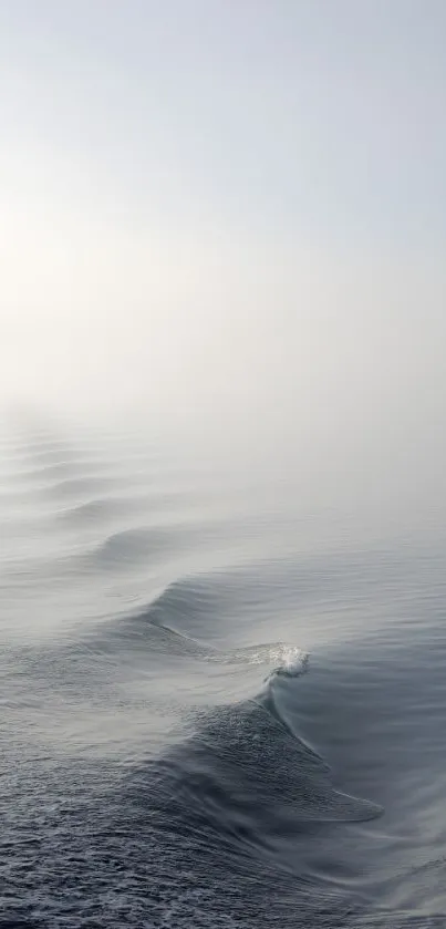 Minimalist ocean wave wallpaper, soft and tranquil with a misty horizon.