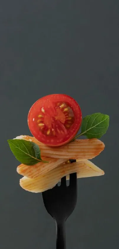 Fork with pasta, tomato, and basil against a dark background.