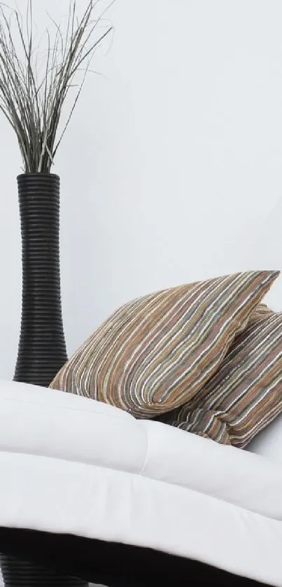 Minimalist wallpaper with vase and pillows.