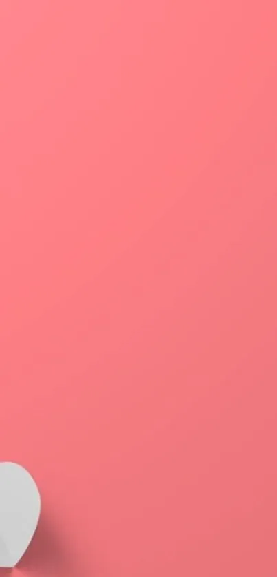 Minimalist coral pink wallpaper with a heart.