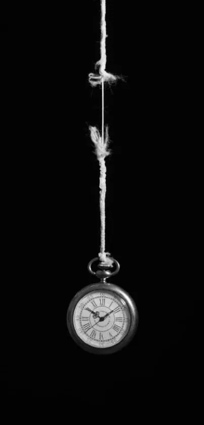 Minimalist black wallpaper with a hanging pocket watch.