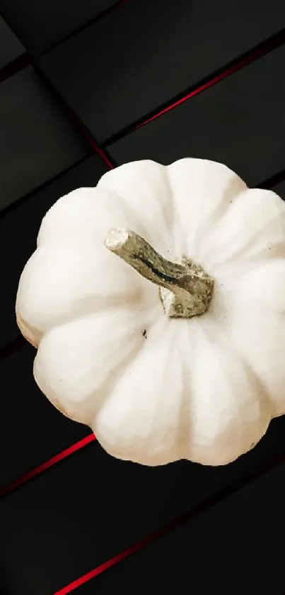 White pumpkin on dark geometric background with red accents.