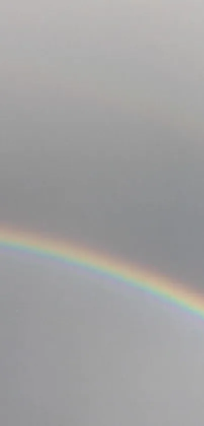 Minimalist wallpaper featuring a rainbow on a gray background.