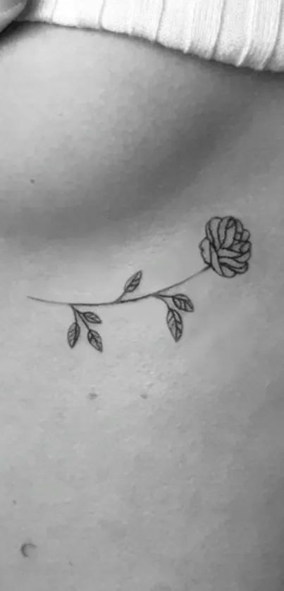 Minimalist rose tattoo line art on skin background.