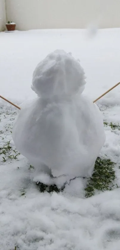 Minimalist snowman on snowy grass in winter.