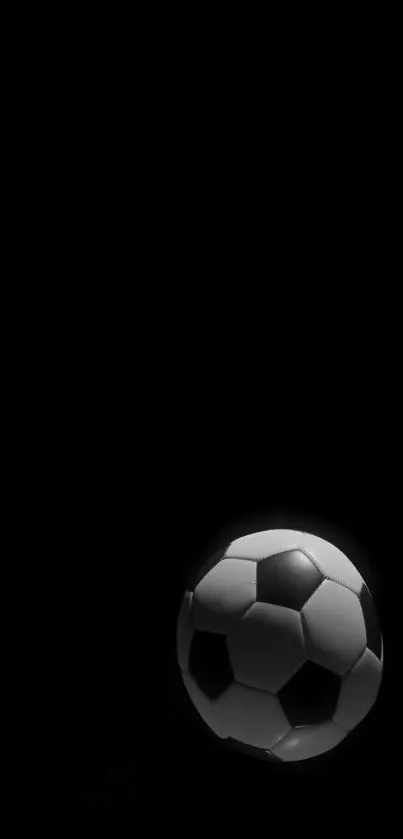 Minimalist black and white soccer ball on dark background.