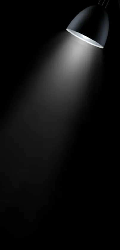 Minimalist black wallpaper with a focused spotlight beam.