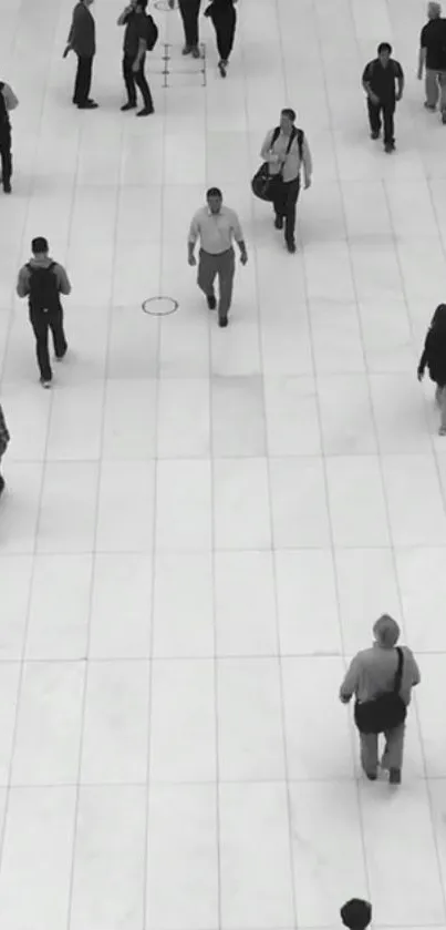 Black and white urban walkway with people in motion.