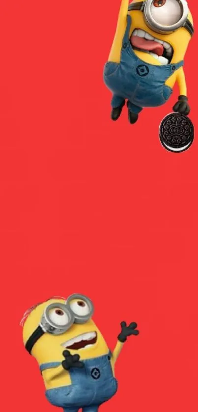 Two Minions on a vibrant red background, reaching for a cookie.