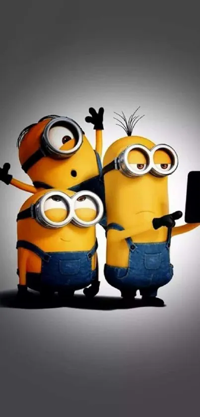 Three playful Minions taking a selfie on a mobile wallpaper.