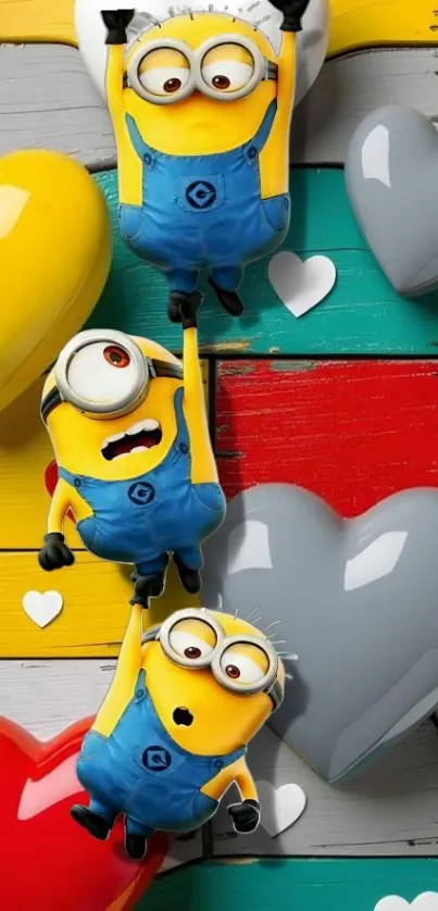 Three minions with colorful heart background