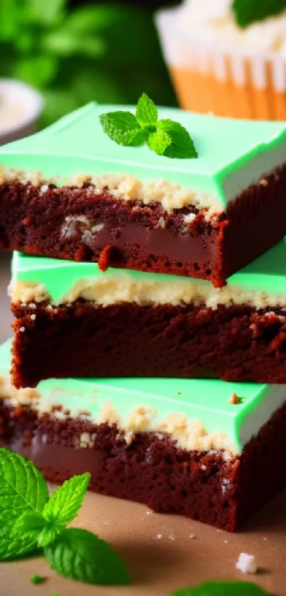 Stack of mint chocolate brownies with mint leaves on top.