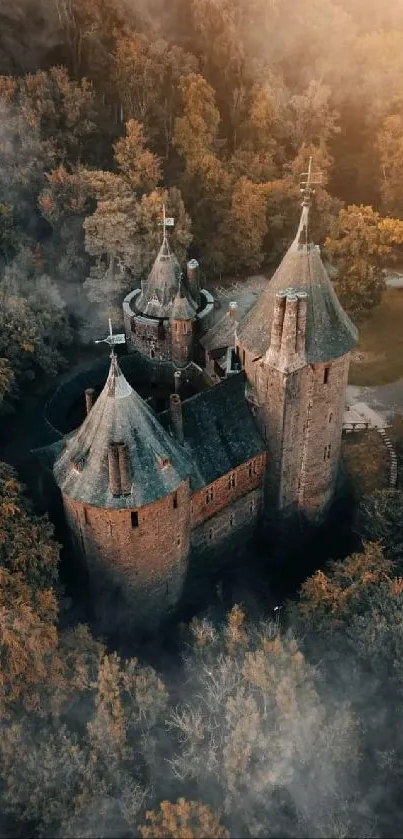 Aerial view of a medieval castle surrounded by fog in an autumn forest.