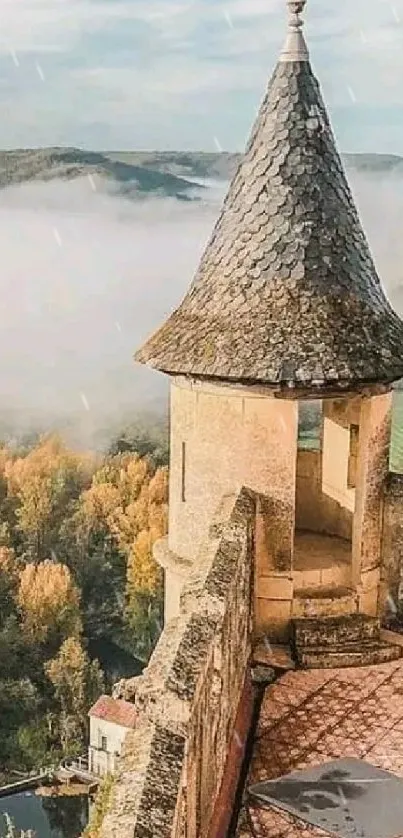 Castle tower overlooking a misty river valley covered in autumn foliage.