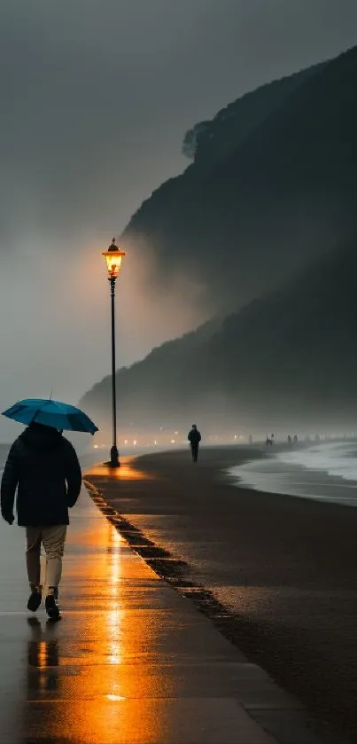 Person with umbrella walks on misty coastal path at dusk, reflecting lamppost glow.