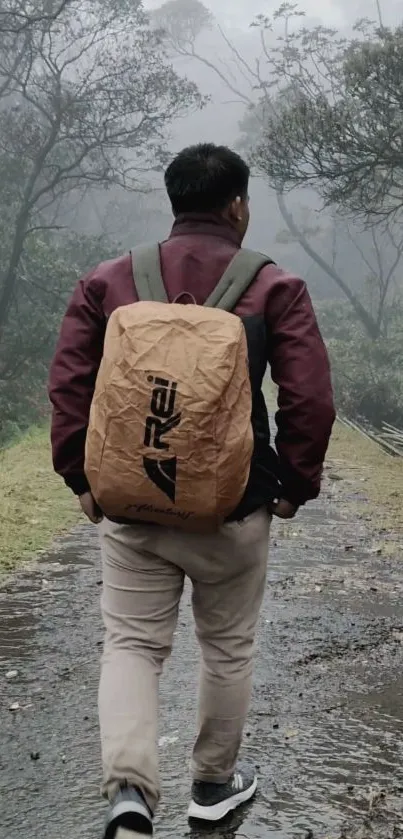 Lone hiker walking down a misty forest path with a brown backpack.