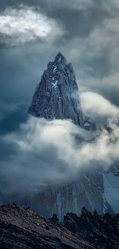 Mountain peak shrouded in clouds with a dramatic view.