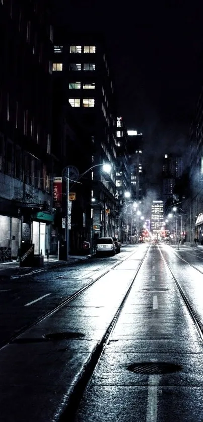 Misty urban night street with tall buildings.