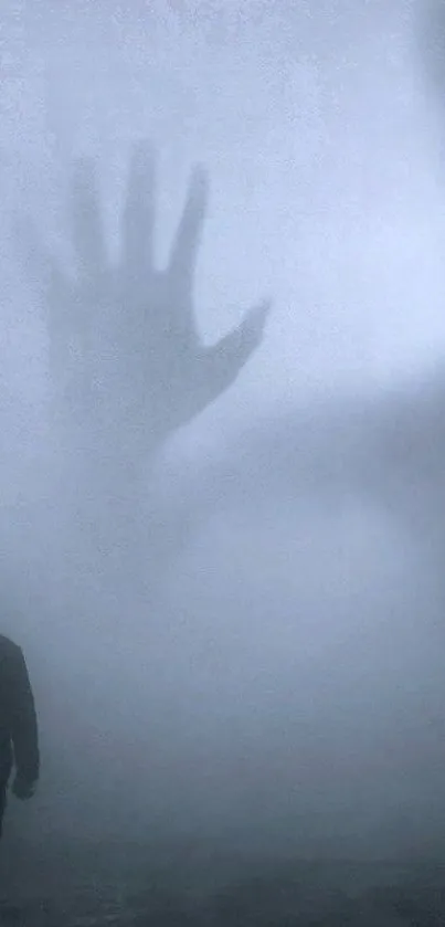 Misty silhouette with large shadow hand on foggy background.