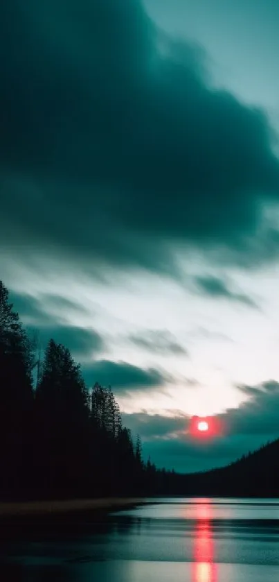 Misty sunset over calm lake with clouds.