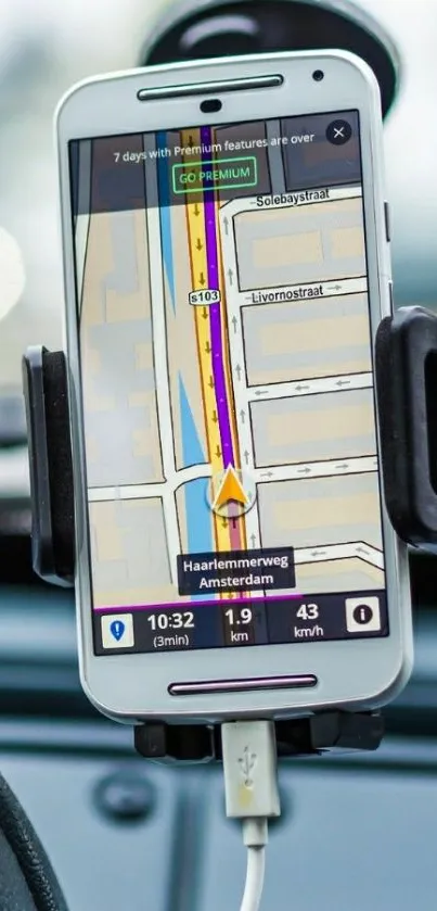 Mobile phone with GPS navigation in car holder.