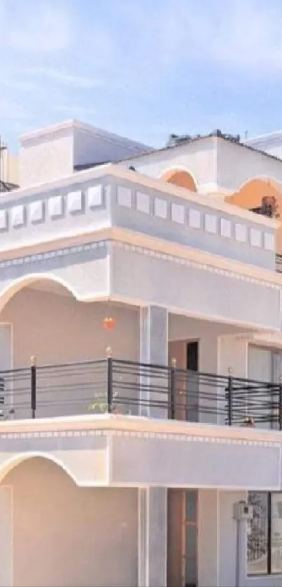 Modern white building with elegant architectural design under a blue sky.