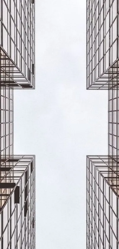 Symmetrical skyscraper architecture against a light sky backdrop.