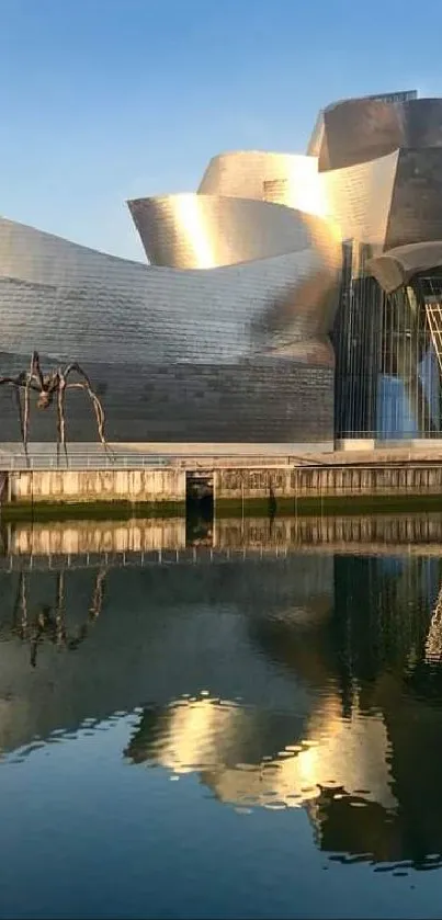 Contemporary building with reflective water view at sunset.