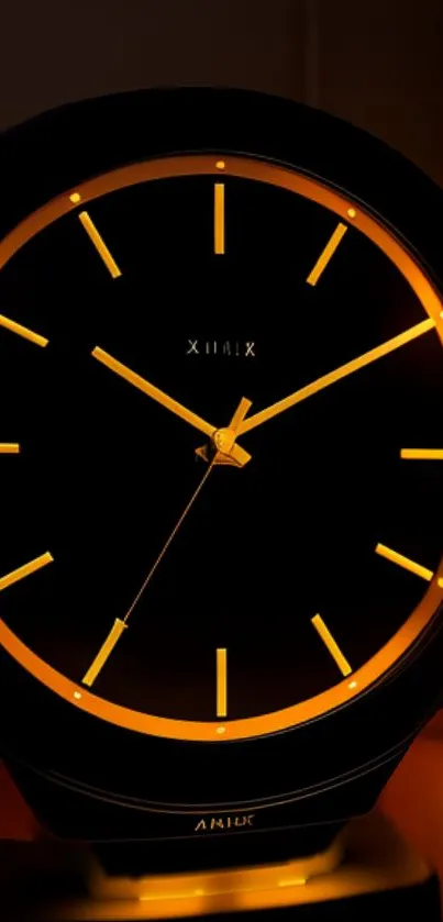 Modern black clock with gold highlights on a stylish wallpaper.