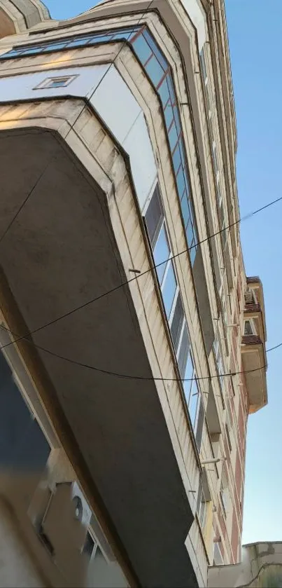 Upward perspective of a modern building against a clear sky.