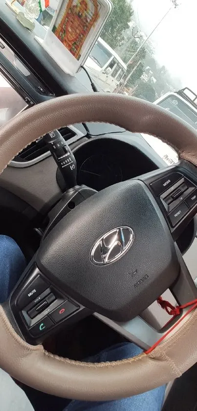 Close-up of a modern car steering wheel in a stylish vehicle interior.