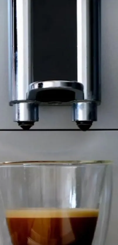 Sleek coffee maker with fresh espresso in glass cup.