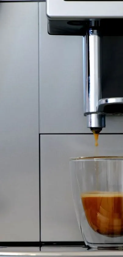 Modern coffee maker with espresso shot in a glass cup.