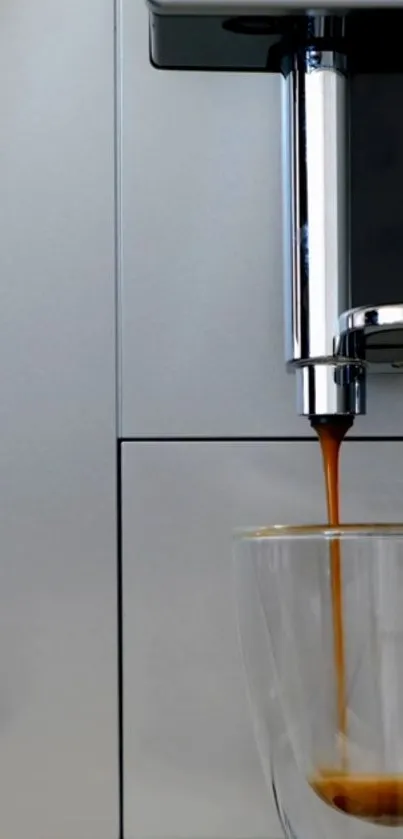 Espresso machine pours rich coffee into a clear cup against a silver background.