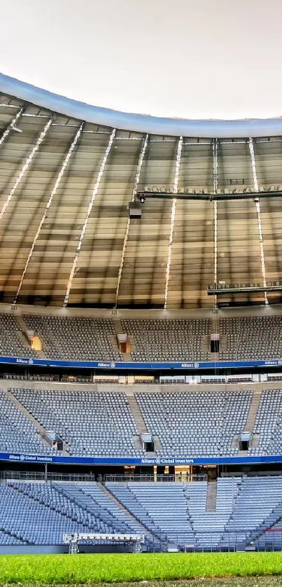 Interior view of a modern football stadium with green field and expansive seating.