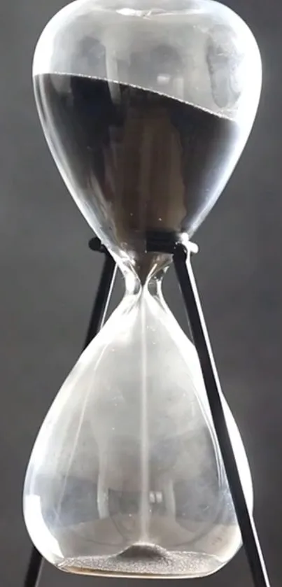 Sleek and modern hourglass against a gray background.