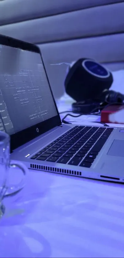 Modern laptop with blue lighting on a tech-inspired desk.